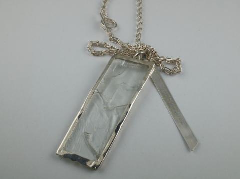 Hiddenite crystal with silver poem 