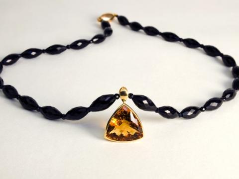 Citrine set in gold on black Spinel beads